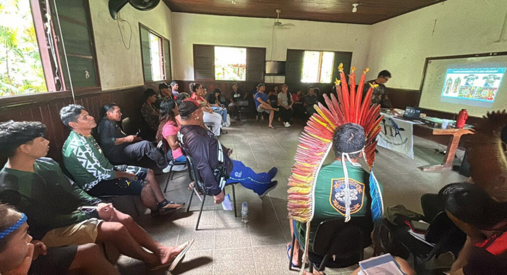 Guardian group members listening during a meeting in a classroom in Santarém